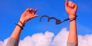 Hand cuffs breaking free from wrists as a metaphor of removing limiting beliefs